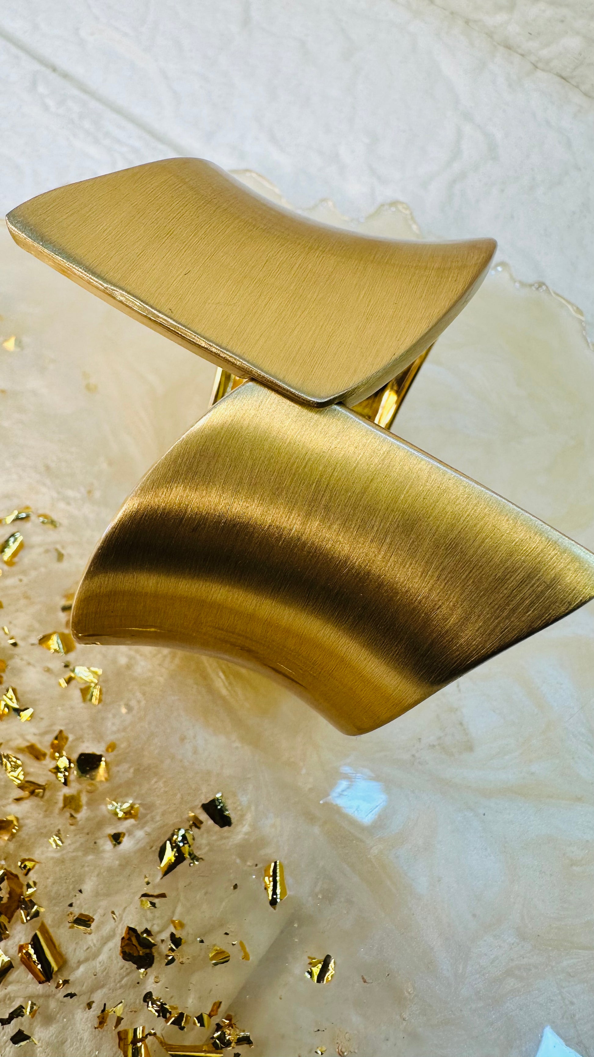 Geometric gold cuff bracelet styled on hand for festive and party wear