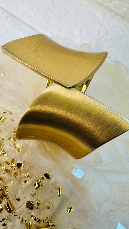 Geometric gold cuff bracelet styled on hand for festive and party wear