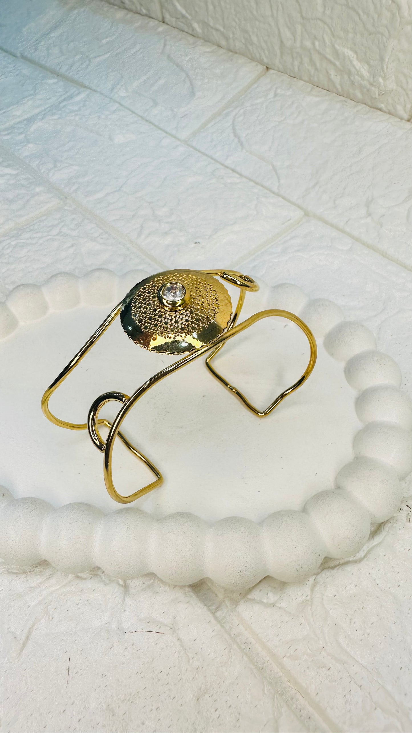 Flatlay of hammered gold disc pearl cuff bracelet – HeyBae statement jewelry