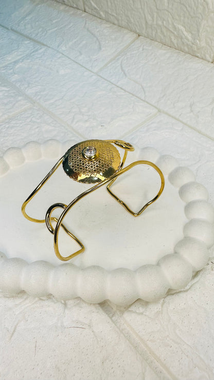 Flatlay of hammered gold disc pearl cuff bracelet – HeyBae statement jewelry