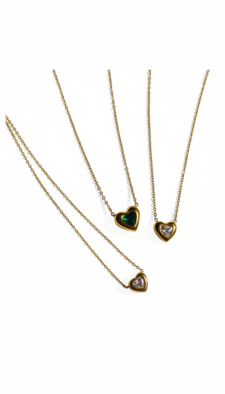 Three gold necklaces with heart-shaped pendants on a white background