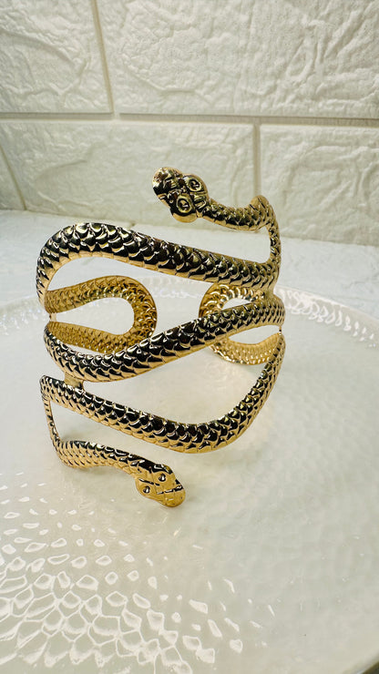Flatlay of gold snake cuff bracelet – HeyBae statement jewelry