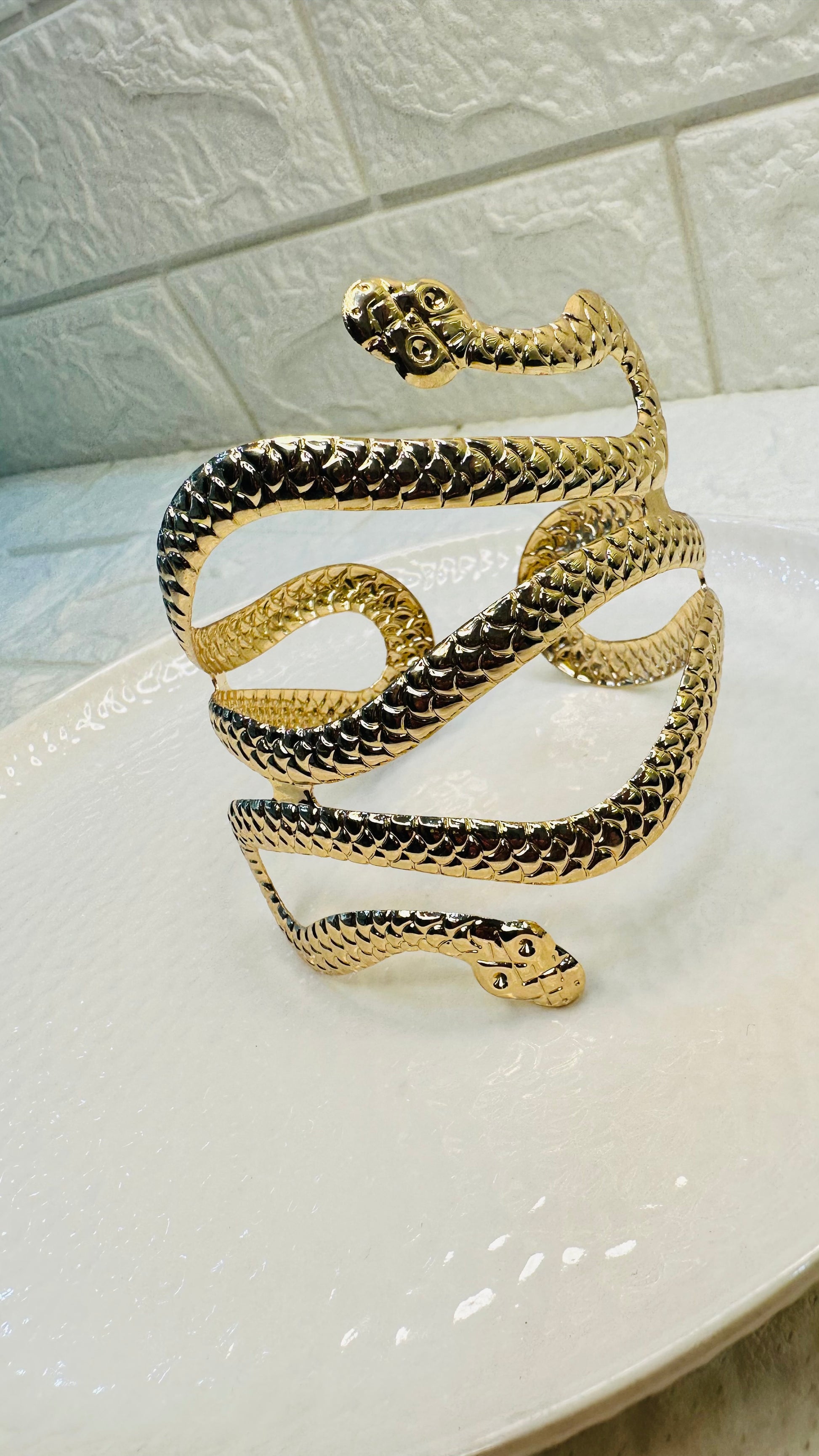 Gold snake cuff bracelet styled on hand for festive and party wear