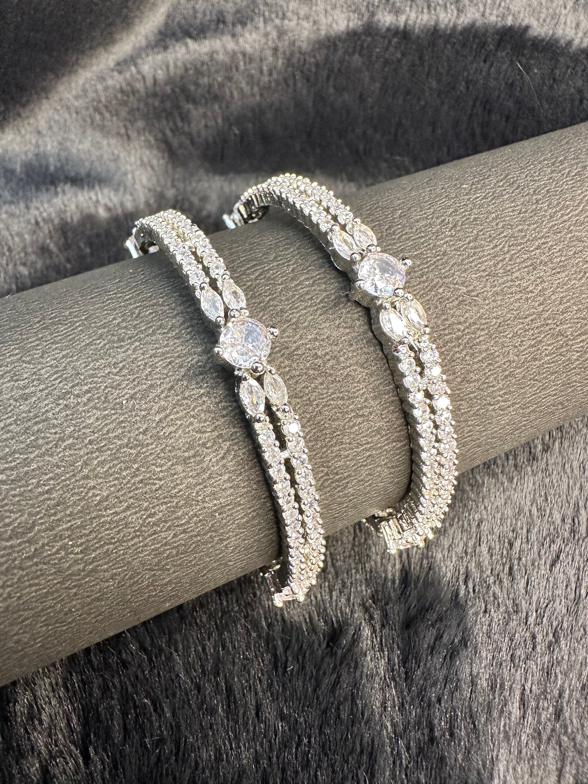 tack of HeyBae silver and gold bangles