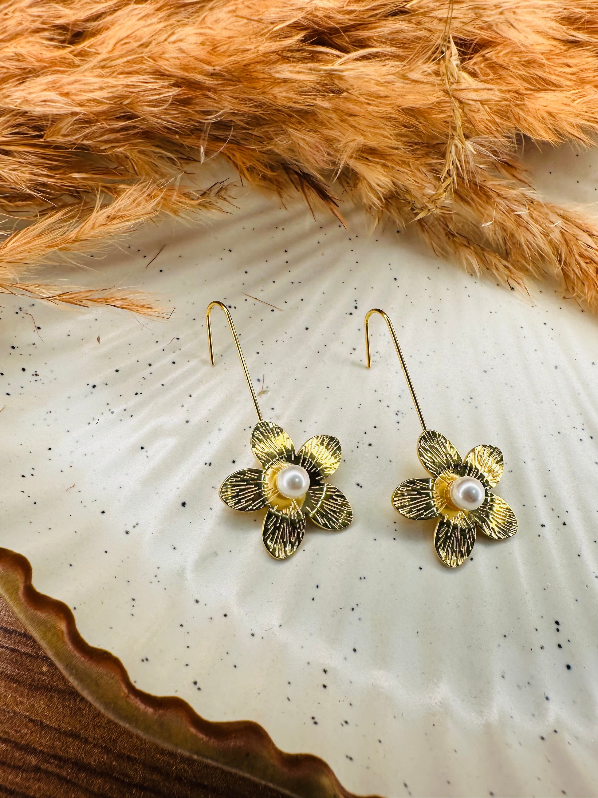 Side View of HeyBae Sleek Gold-Plated Teardrop Flower Earrings