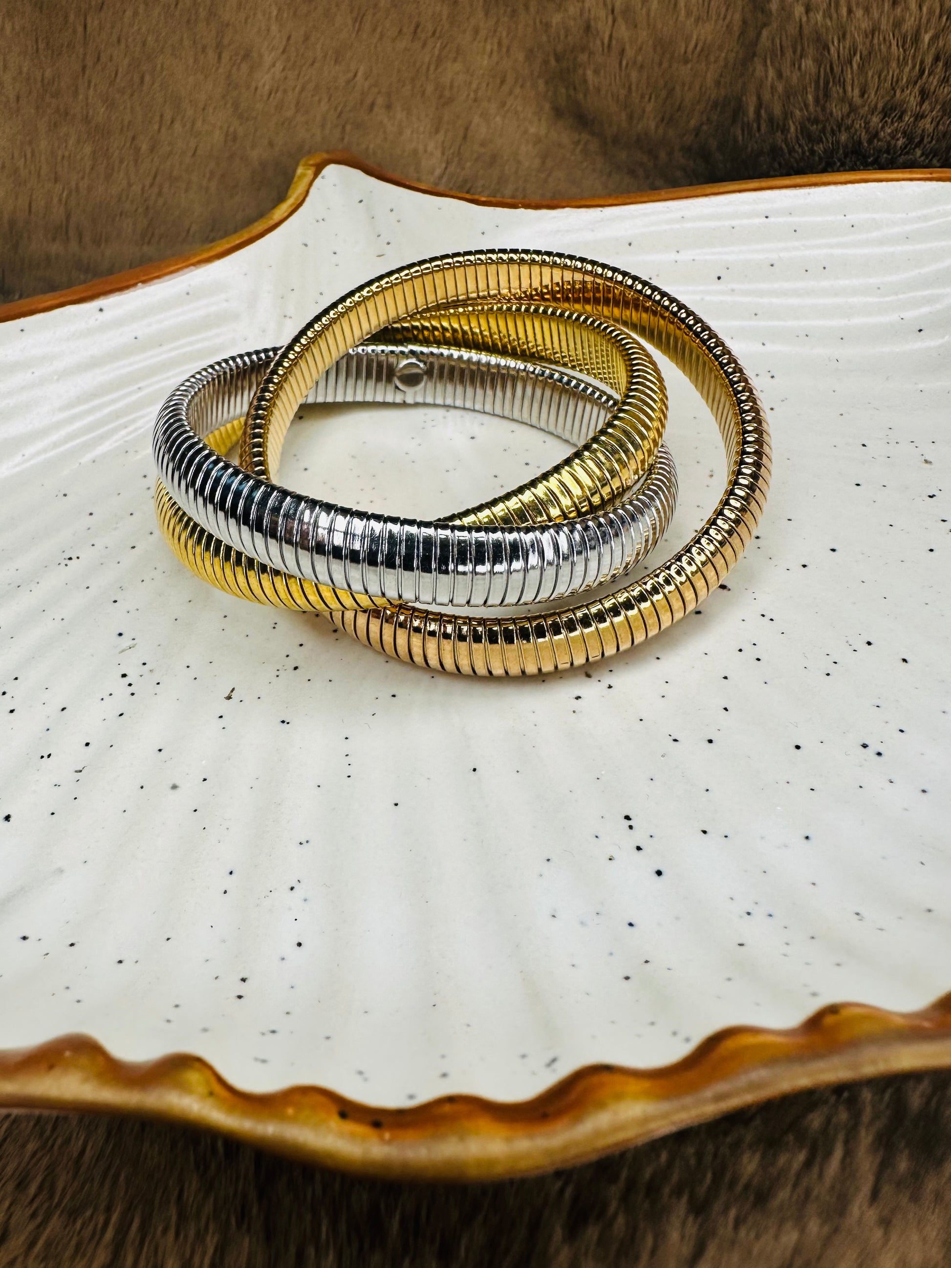 Close-up of HeyBae Triple Coil Gold Bracelet with High Polish Finish