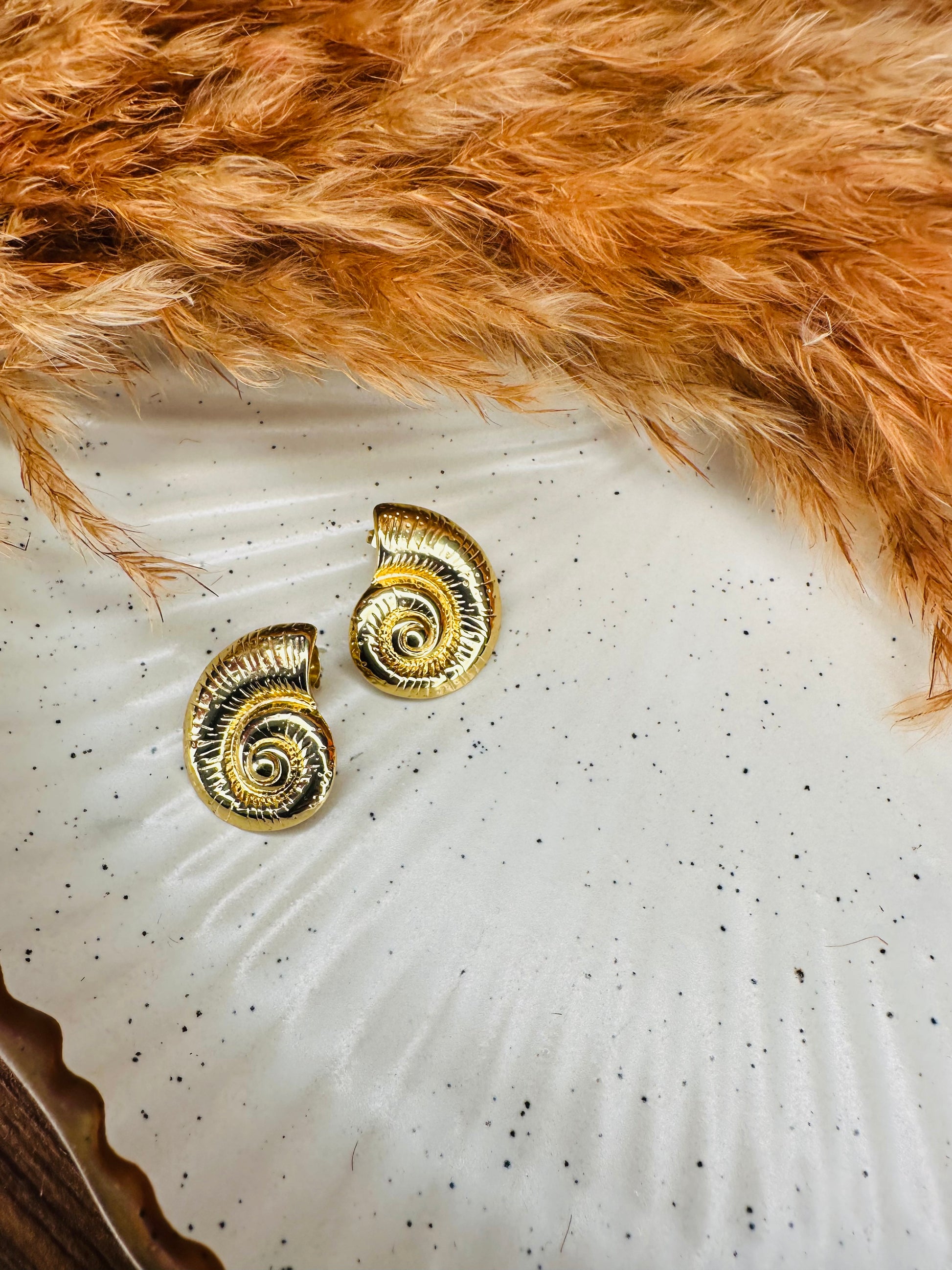 Close-up of HeyBae Gold-Tone Twisted Oval Hoop Earrings