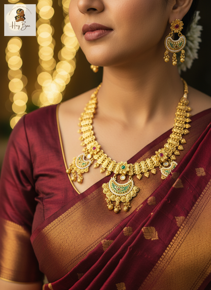 Woman wearing a gold necklace and earrings with a blurred bokeh background