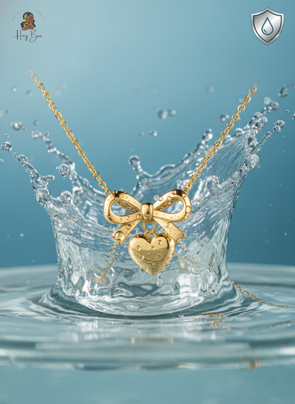 Gold necklace with a heart and bow pendant on a water splash background