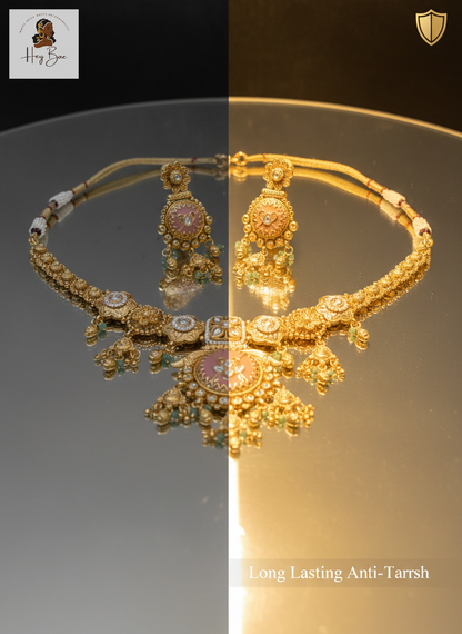Gold necklace with intricate designs on a reflective surface, showing different lighting conditions.