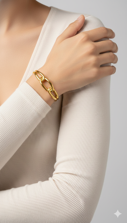 Gold bracelet on a person's wrist with a neutral background